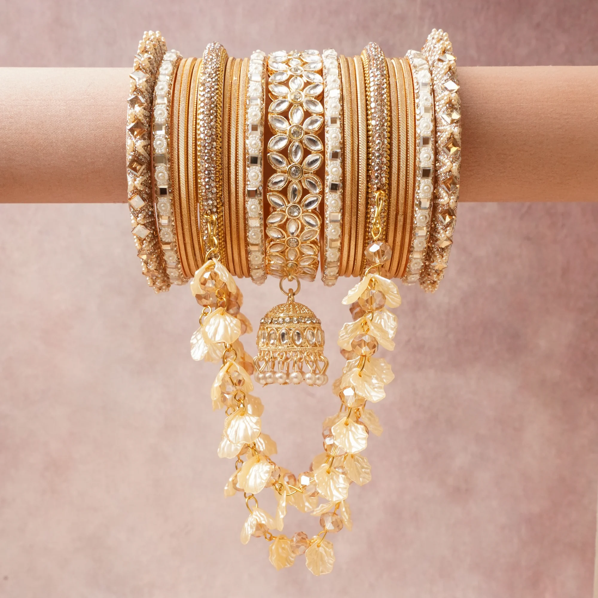 A majestic Champagne Gold set, complemented by Brilliant White, Lustrous Ivory, Warm Translucent Taupe featuring Gold-toned Alloy, Kundan Glass, Cubic Zirconia, Imitation Pearl, Resin/Acrylic, Glass Beads, Seed Beads.
Rich, ceremonial, and designed to be passed through generations.